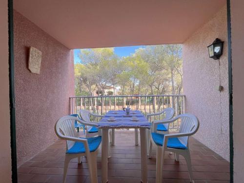 une table et des chaises assises sur un balcon dans l'établissement Studio cabine avec piscine, tennis et parking à 400m de la plage - 4 couchages, Saint-Aygulf - FR-1-226A-89, à Saint-Aygulf