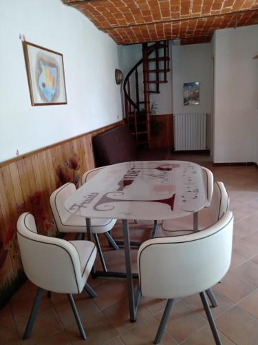 a white table and chairs in a room at Bed and Breakfast Nicole Ponti in Ponti