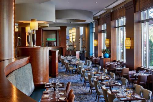 a dining room filled with tables and chairs at Renaissance Montgomery Hotel & Spa at the Convention Center in Montgomery