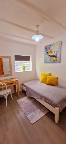 a bedroom with a bed and a table and a window at Cottage in Newquay