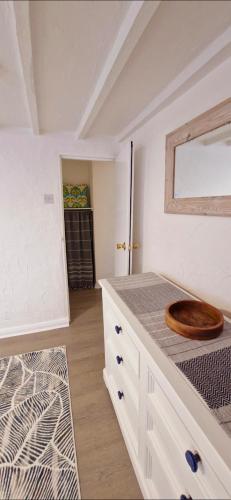 a bathroom with a counter with a wooden bowl on it at Cottage in Newquay