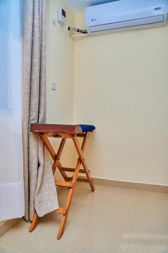 a small wooden table in a room with a curtain at SHIMBA SPRINGS MBUYU. ( Malindi) in Malindi