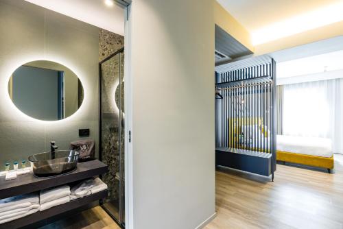 a bathroom with a sink and a mirror at MH SUITES Plebiscito in Naples