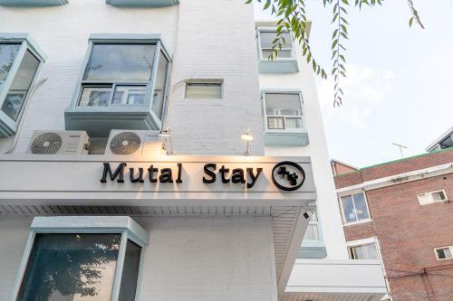 a building with amillstay sign on the front of it at Mutal Stay in Seoul