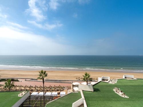 a view of a beach with chairs and the ocean at Amadil Ocean Club in Agadir