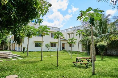 a park with a bench in front of a building at SHIMBA SPRINGS MBUYU. ( Malindi) in Malindi