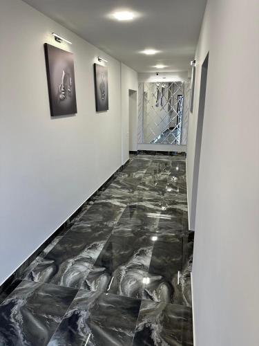 a hallway with a marble floor in a building at Lux Plaza in Pʼarakʼar