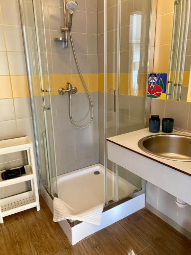 a bathroom with a shower and a sink at Yacht Club Residence Sopot in Sopot