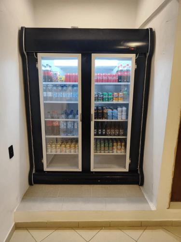 a refrigerator with two doors full of drinks at Villa Bilac - Amplos Studios 2km da Vila Germânica in Blumenau