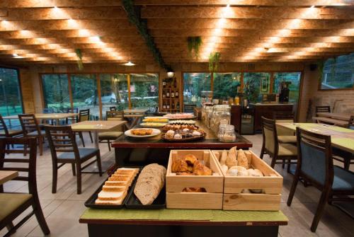 a restaurant with a table filled with bread and pastries at Quinta do Caminho, AL in Valença