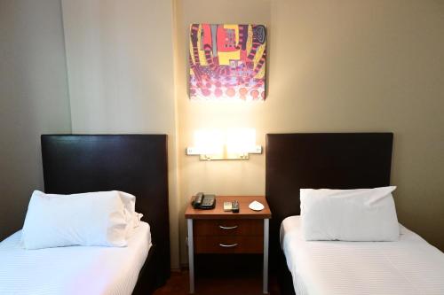 Cama o camas de una habitación en Hotel Mendoza