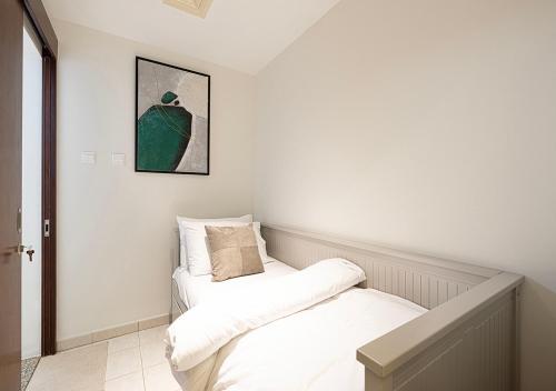 two beds in a room with white walls at Dubai Marina Luxury 4 BHK # Sea, Ain Dubai & Palm View # in Dubai