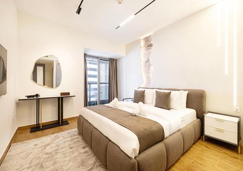 a bedroom with a large bed and a mirror at Dubai Marina Luxury 4 BHK # Sea, Ain Dubai & Palm View # in Dubai