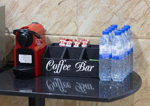 a coffee bar with bottles of water on a table at Dubai Marina Luxury 4 BHK # Sea, Ain Dubai & Palm View # in Dubai