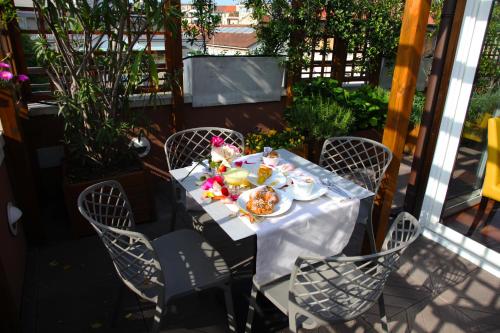 a table with a plate of food on a patio at Hotel Metrò in Milan