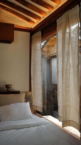 a bedroom with a bed and a window with curtains at Unwadang Private Luxury Hanok House in bukchon in Seoul