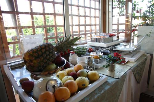 a buffet with fruits and vegetables on a table at Hotel Metrò in Milan