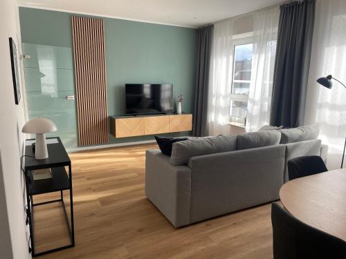 a living room with a couch and a television at Moderne Wohnung - renoviert 2024 in Solingen