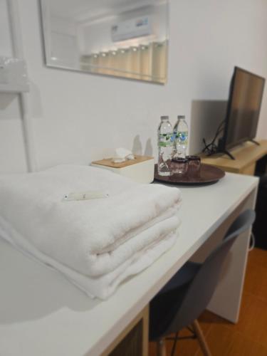 a bathroom counter with white towels on it at Ratanasiri Hotel in Chaiyaphum