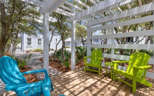 two chairs on a porch with a white pergola at Bimini by Oversee 30A in Carillon Beach