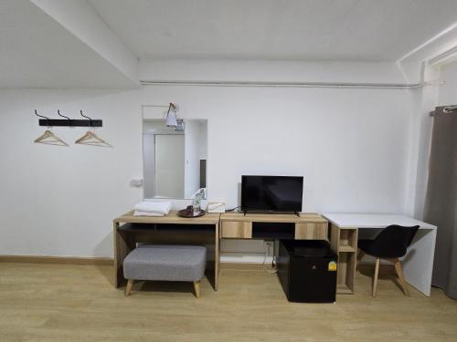 an office with a desk with a computer and a chair at Ratanasiri Hotel in Chaiyaphum