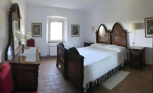 a bedroom with a large bed and a window at La Casa Rossa 2 in Marina di Bibbona