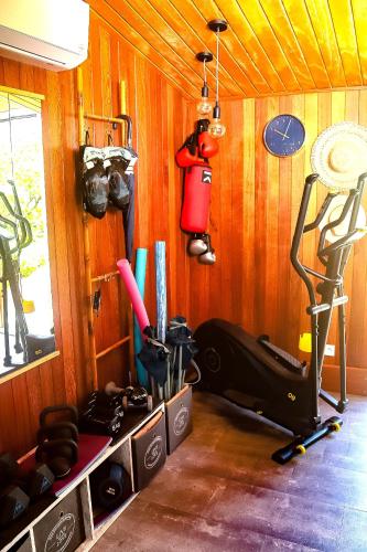 a room with a gym with wood paneled walls at La Villa Baie du Marin in Le Marin