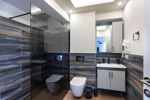 a bathroom with a toilet and a sink at by Abraham Galata in Istanbul