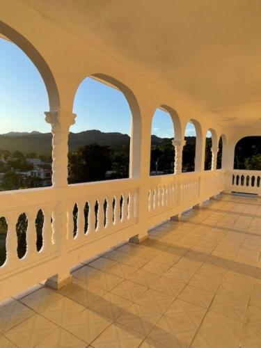 a balcony with arched windows and a view at Montecielo-Mountain View Escape 20 minutes to Airport in Canovanas