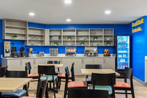 a dining area with tables and chairs in a restaurant at Days Inn by Wyndham Steinbach in Steinbach