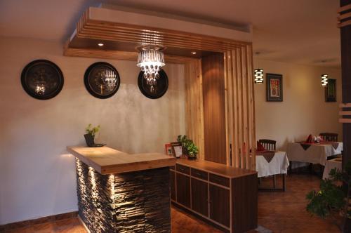 a restaurant with a bar in the middle of a room at Hotel Ekant in Chail