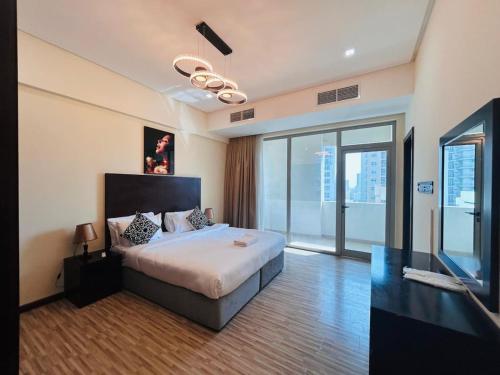 a bedroom with a large bed and a large window at Aspire Tower-Two Bedroom Urban Haven Juffair in Manama