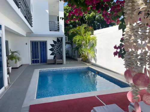 a swimming pool in the middle of a house at Gaia Residence Deluxe in San Felipe de Puerto Plata