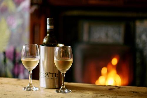 two glasses of white wine next to a bottle of wine at The Swan Hotel and Spa in Newby Bridge