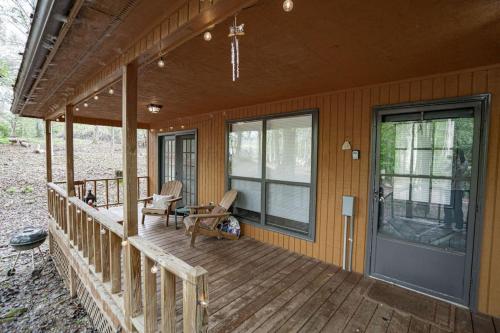 a porch of a house with a door and chairs at Hansel - Spacious Cabin - Views - Greenery - Deck in Blairsville