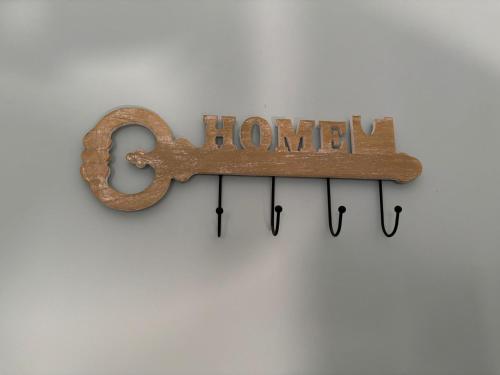 a horseshoe sign with the word home hanging on a wall at Casa vacanze Vista Castello in Oria