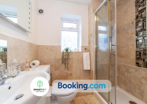 a bathroom with a shower and a toilet and a sink at 2Bedroom Apt in Egham with Free Parking in Egham