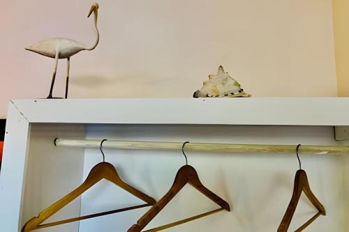 a white shelf with hangers on it at Pousada Salinas de Atins in Atins