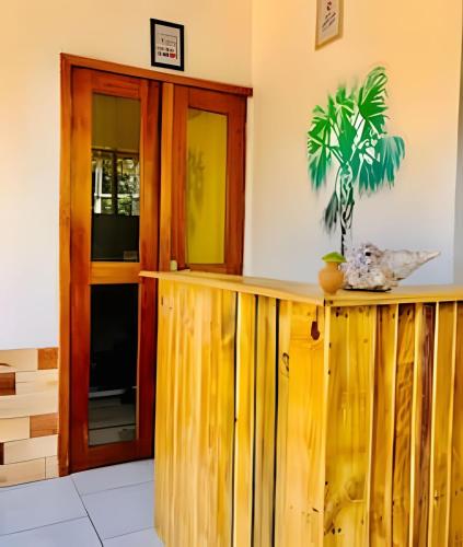 a wooden counter with a plant on top of it at Pousada Salinas de Atins in Atins
