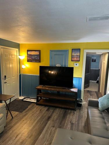 a living room with a flat screen tv and a couch at 3 PM Checkout! in Moorhead