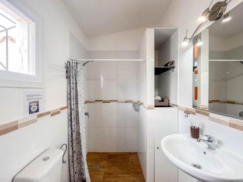 a white bathroom with a shower and a sink at Private Chill-out Terrace Bungalow - Pool in San Bartolomé de Tirajana