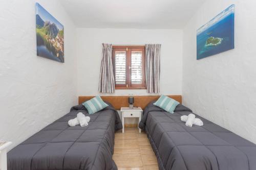 two beds in a room with stuffed animals on them at Private Chill-out Terrace Bungalow - Pool in San Bartolomé de Tirajana