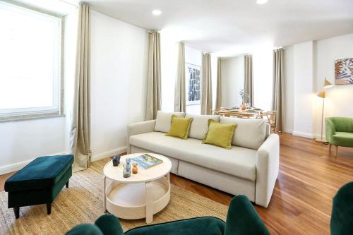 a living room with a couch and a table at Green Essence Duplex in Faro by Misha's Place in Faro