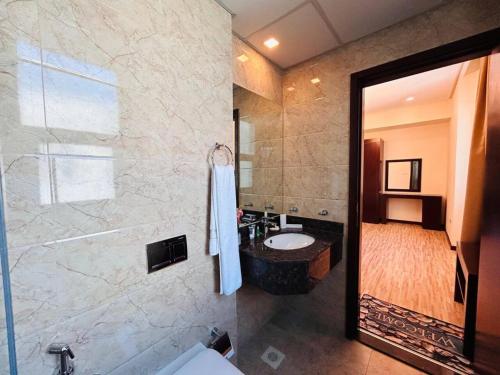 a bathroom with a sink and a shower at Aspire TowerTwo Bedroom Pilot Paradise in Manama