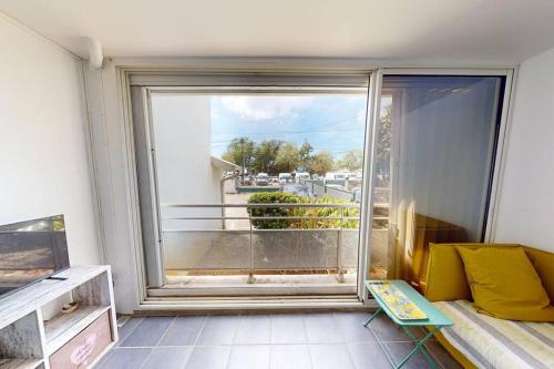 a room with a large window with a view at Appartement face à la mer 2 chambres in Le Diamant