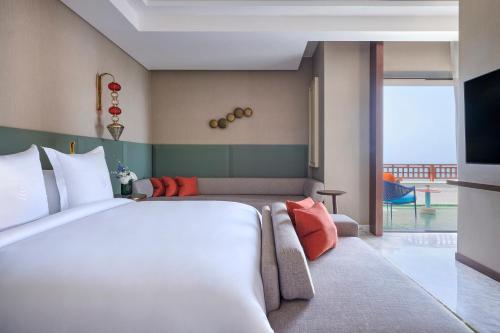 a hotel room with a large bed and a tv at Four Seasons Hotel Rabat at Kasr Al Bahr in Rabat