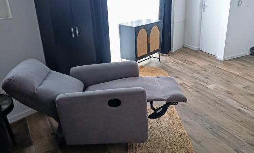 a living room with a couch and a chair at La Pierre 2 studio entier in Tartas