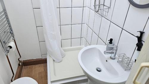 a white bathroom with a sink and a toilet at Convenient En-suite Double in Oxford