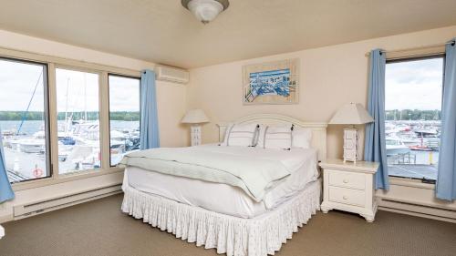 a bedroom with a bed with a view of a marina at Harbor Guest House in Fish Creek