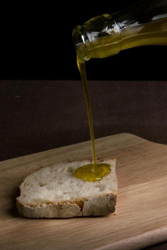 a piece of bread with mustard on a cutting board at Agriturismo Casale Di Gricciano in Cerveteri